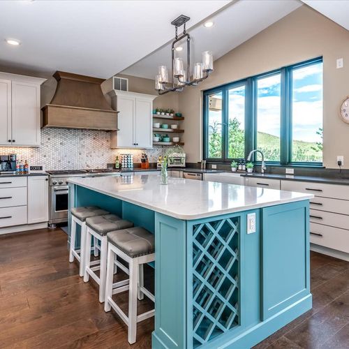 - chef’s kitchen stuns with a bold blue island, quartz counters, and gas range
- built in wine rack, open shelving, and modern lighting add both style and ease
- gather around the island for meals, wine, or mountain view conversations