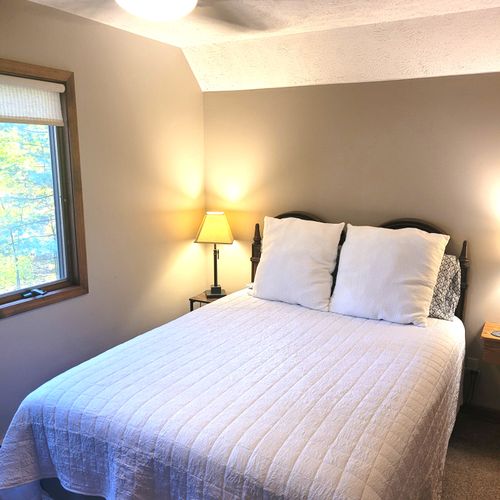 BEDROOM #3 (SECOND FLOOR):  Comfy bed with a queen-size bed, nightstand, ceiling fan, dresser, and closet.