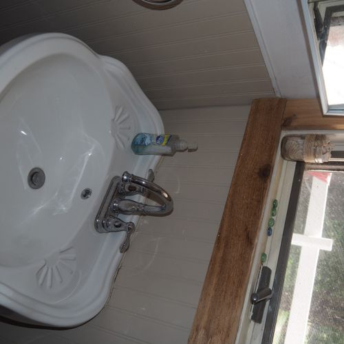 Bathroom:  small, but full bathroom, with entrance from the living room. Includes sink, mirror, toilet, and shower.