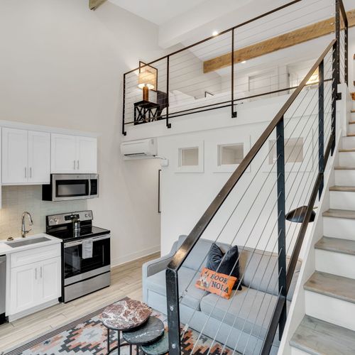 Open loft layout blending kitchen, lounge & sleeping areas in one stylish space.