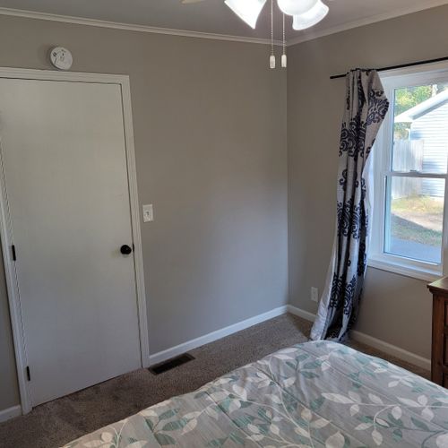 Bedroom #1:  features a queen-size bed, ceiling fan, nightstand, lamp, closet, and dresser.