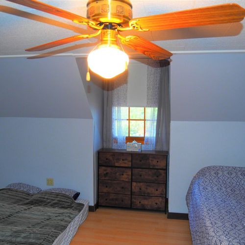 Bedroom #3 (second floor):  includes a queen-size bed, a full-size bed, and a twin-on-full bunk bed. Also has a dresser. Closet, and ceiling fan.