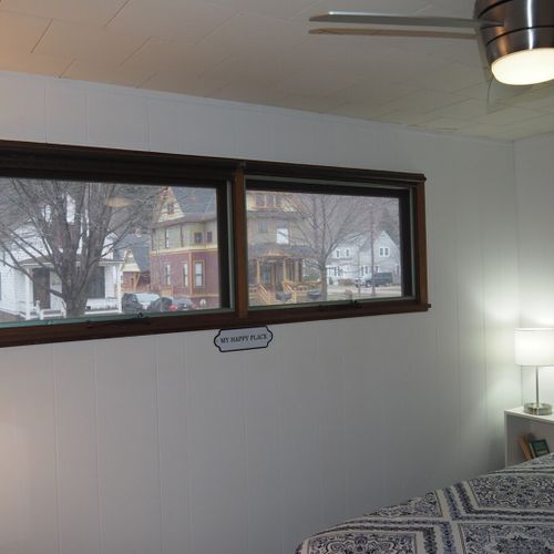 Bedroom #1:  features a queen-size bed, nightstands with lamps, ceiling fan, chair, dresser, closet, and full-length mirror.