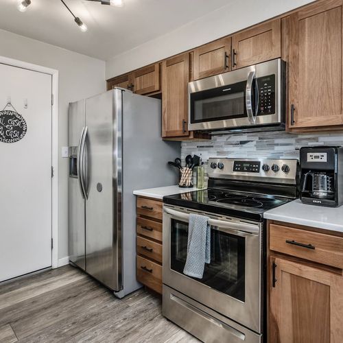 - stainless steel appliances including a french door fridge and electric range
- modern backsplash and wood cabinetry create a warm functional atmosphere
- fully equipped with coffee maker knives and all your cooking essentials