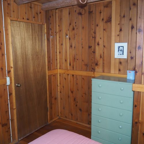 Bedroom #1 (main floor):  features a queen-size bed, nightstands with lamps, a dresser and a closet.