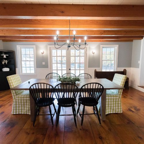 Walk into White Tail Farmhouse to an open concept dining room with large exposed wood beams throughout.
