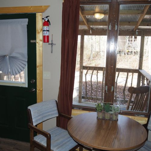 Main room:  features a small dining table with chairs, kitchenette  / sink, one twin-on-full bunk bed, and one twin-on-twin bunk bed.