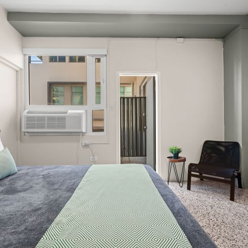 Immerse yourself in the calming atmosphere of this bedroom. The soft lighting and comfortable furnishings create an ideal setting for unwinding after your day's adventures.