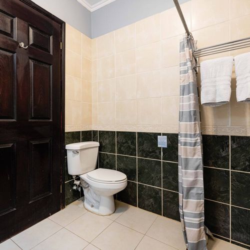 Bathroom with shower, sink and toilet.