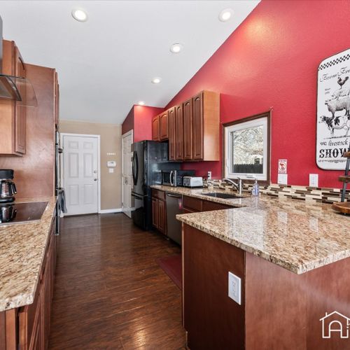 The large kitchen boasts modern appliances, granite countertops and cooking essentials for your convenience.
