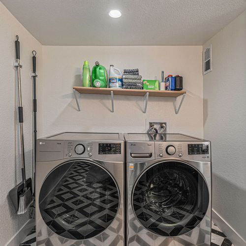 - full size washer and dryer stocked with detergents and cleaning supplies for your stay
- open shelving keeps essentials within reach while maintaining a neat and tidy look
- modern appliances, mop set, and ample lighting make chores quick and easy