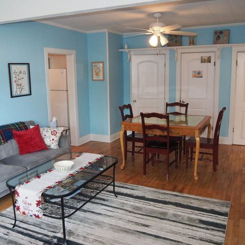 Dining area:  there is a hand-painted square dining table between the kitchen and living room with seating for 4 adults.