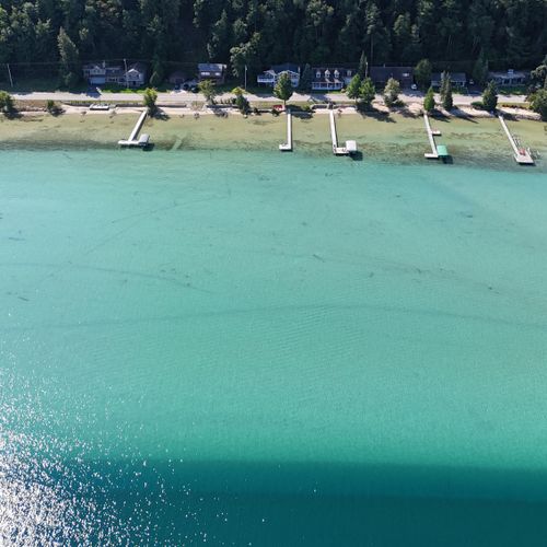 EXTERIOR:  Another aerial photo from in front of the cottage highlighting the beautiful colors of Crystal Lake.