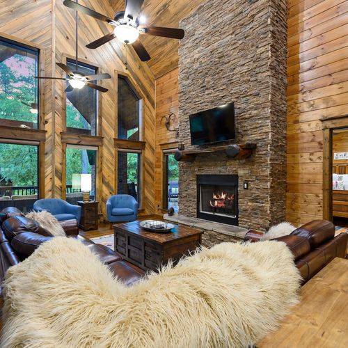 Oversized leather sectional around the stone fireplace!