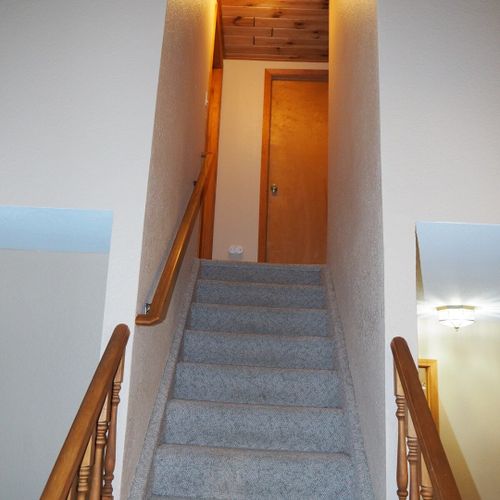 Stairs:  stairs from the first floor to the second floor. The entrance to each of the 3 upstairs bedrooms is near the top of the stairs, with the door to bedroom #2 shown in the photo.