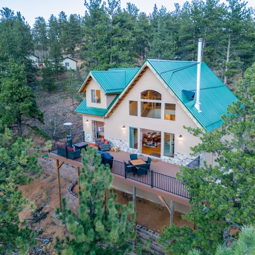 The main patio is accessible from the stairs leading from the front driveway as well as through double doors from the living room and master bedroom