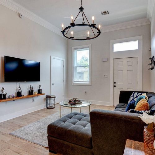 Living area w/ flatscreen TV & comfy seating — settle in and make yourself at home.
