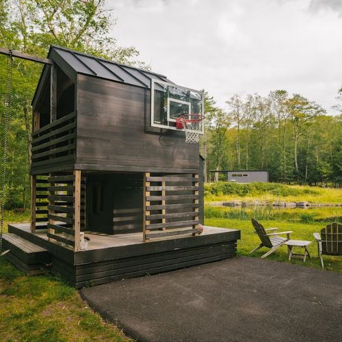 Playhouse with swing and basketball hoop, (guest house in background)