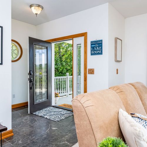 Living room:  the home has a large and lovely living room with comfy furniture, a gas fireplace, a desk, a large television with free living streaming, and great views of betsie lake!
