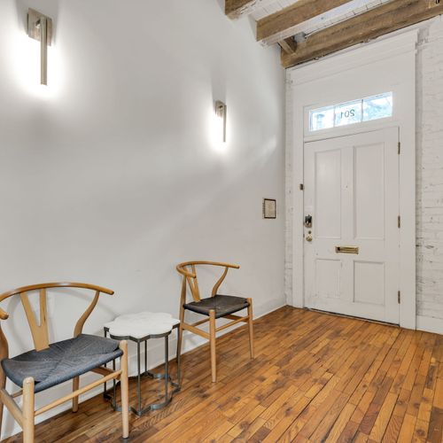 Welcoming entryway with historic charm and cozy seating—your New Orleans stay starts here.