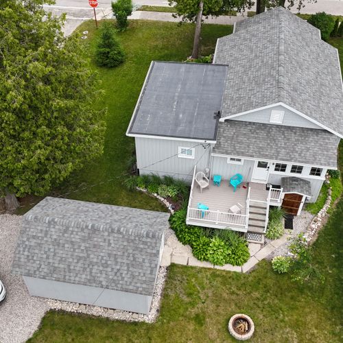 EXTERIOR:  Aerial view of the backyard, deck, and parking area