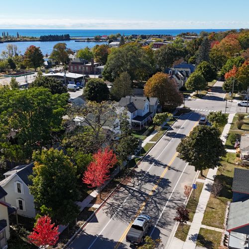 OVERVIEW:  Looking out from above the house (lower right of photo) at Betsie Bay, the Elberta Dunes, Lake Michigan, and downtown Frankfort