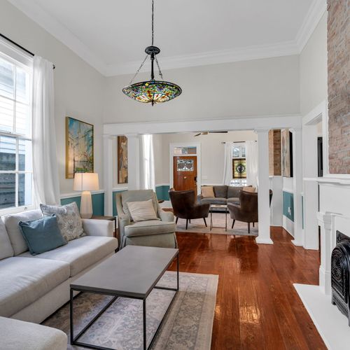 Bright, airy living room w/ hardwood floors & eclectic décor — perfect for gathering after a day out.