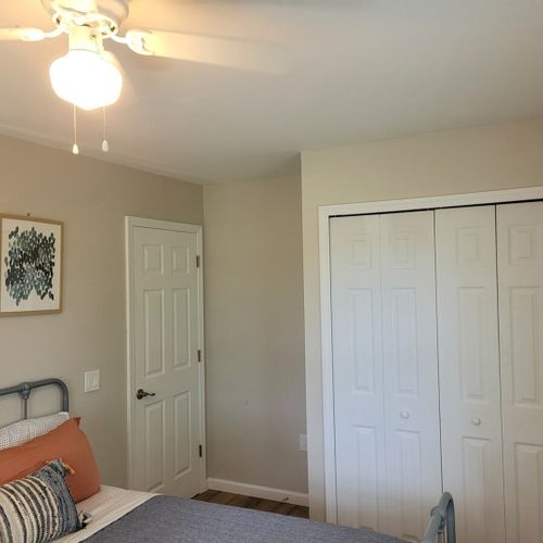 Bedroom #1:  bedroom #1 features a queen-size bed, ceiling fan, dresser, and a closet.