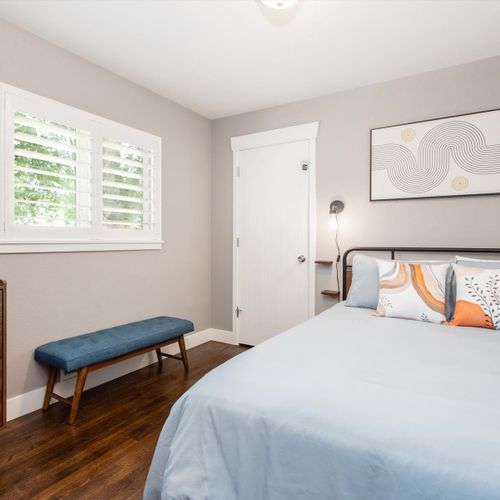 This retro-mod bedroom off the living room offers a queen-sized bed, dresser and bench for added seating.