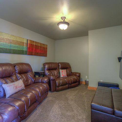 Theater room with a Smart TV and seating for five