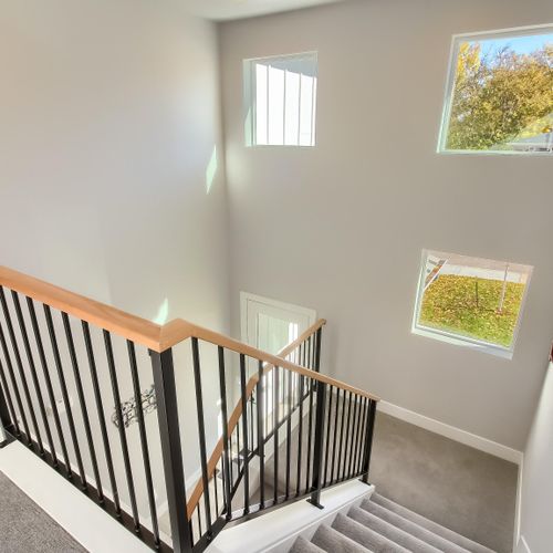 - sunlight floods the stairwell through three large windows that brighten the space