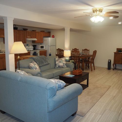 Living room:  the apartment has a very comfortable living room with a sleeper sofa, comfy chair, ceiling fan, table, and television.