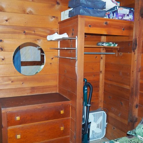 Bedroom #1:  features a full-size bed, chair, dresser, closet, and mirror.