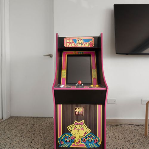 Unleash fun! Unique game room with classic arcade machine for endless entertainment.