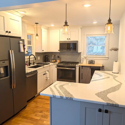 KITCHEN (MAIN FLOOR):  Fully-functional modern kitchen with newer appliances including a dishwasher and a gas range.