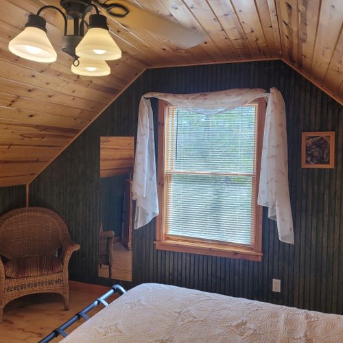Bedroom #2 (upper level):  features a queen-size bed, chair, dresser, closet, ceiling fan, nightstands, and lamp