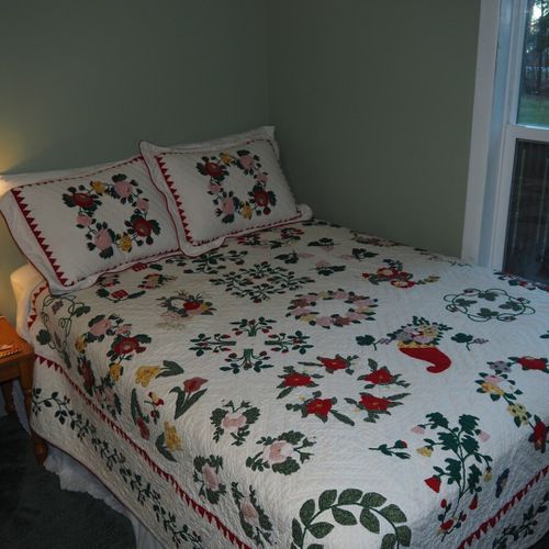 Bedroom #2:  one of the two full-size beds in the bedroom and the bedroom window (which faces the front yard).