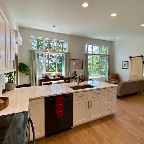 A chef's kitchen with quartz island, stainless appliances, and a Pacific Northwest Seafood Cookbook to inspire your next feast