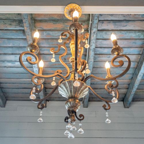Ornate vintage chandelier dripping w/ Southern charm & character.
