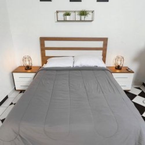 Indulge in peaceful slumber in this elegantly appointed bedroom. A comfortable queen-sized bed, stylish bedside tables with soft lighting, and captivating wall art create a serene and inviting atmosphere. Your perfect night's rest awaits.