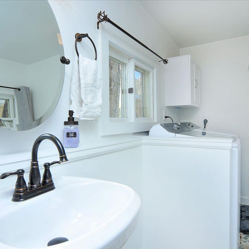 Laundry room is connected to the first floor bathroom. Features a walk-in shower.