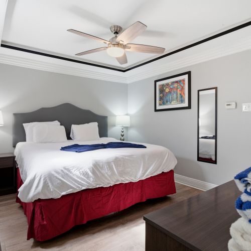Drift off in this calm bedroom w/ a plush bed & soft, neutral tones.