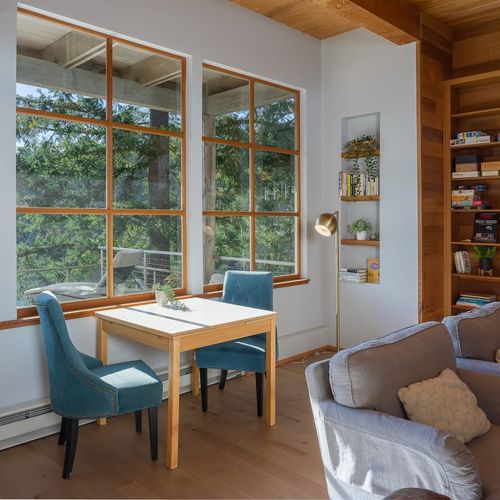 Living room seating with fireplace, and shelf of books and games