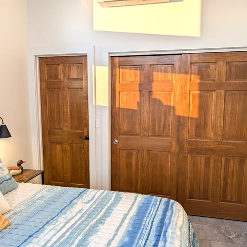 BEDROOM #3 (UPPER LEVEL):  Gorgeous top floor (third floor) bedroom with a king-size bed, nightstands, nightlamps, private television, dresser. closet, amazing view of Crystal Lake, and private entrance to the top floor bathroom!