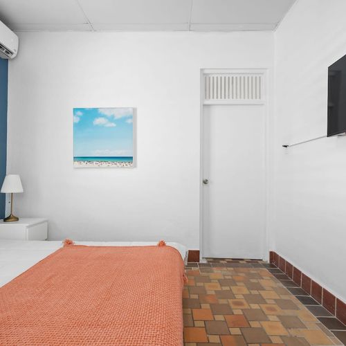 This comfortable bedroom has everything you need for a relaxing stay, including two lamps.