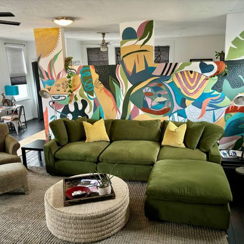 Sink into the plush green sofa & let the colorful mural set the mood for your stay.