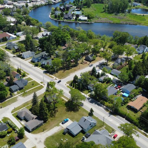 Exterior:  an aerial photo with the house in the foreground and the au sable river in the background.