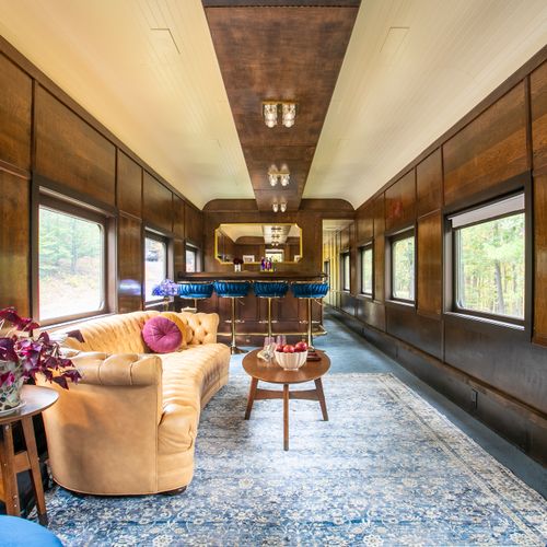 Enter into the living room, complete with a bar, projector and a big comfy chesterfield.