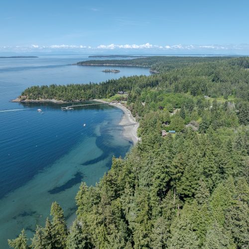 Point Kimple with boats pulling out of the dock is in the foreground.  What looks like clouds on the horizon is Mt Baker and the Cascadian Wilderness Area.
