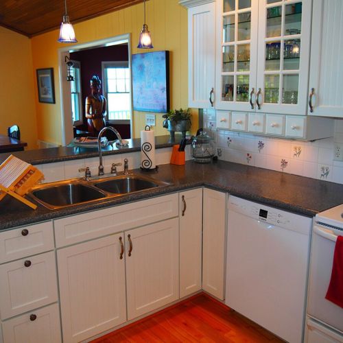 Kitchen:  the home has a large, beautiful, and very functional kitchen with all appliances including a dishwasher. There is a good supply of cooking and dining utensils included as well.